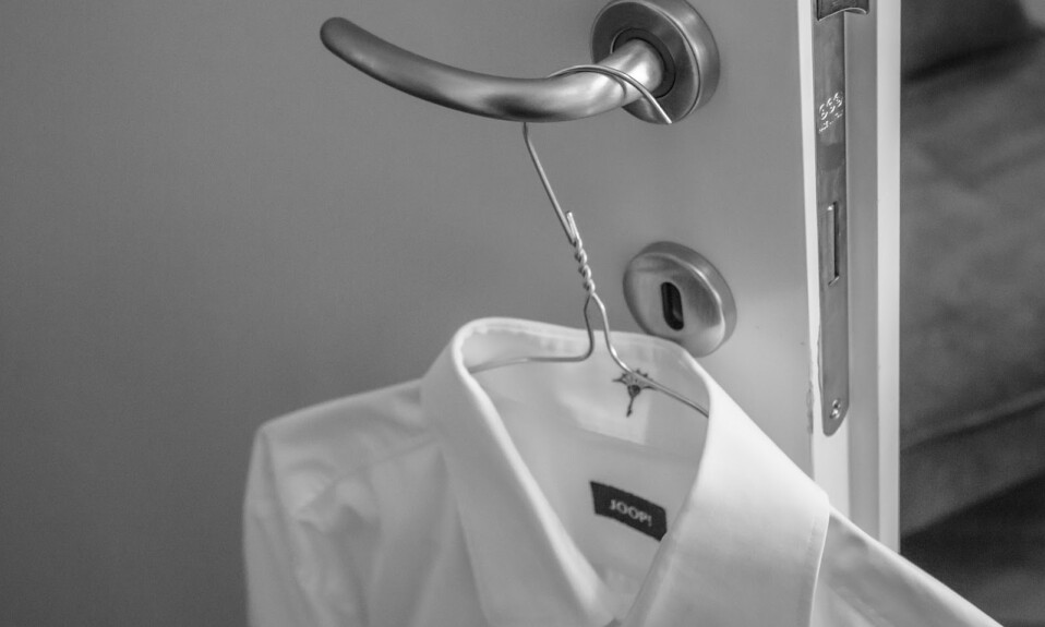 white shirt hung on the door