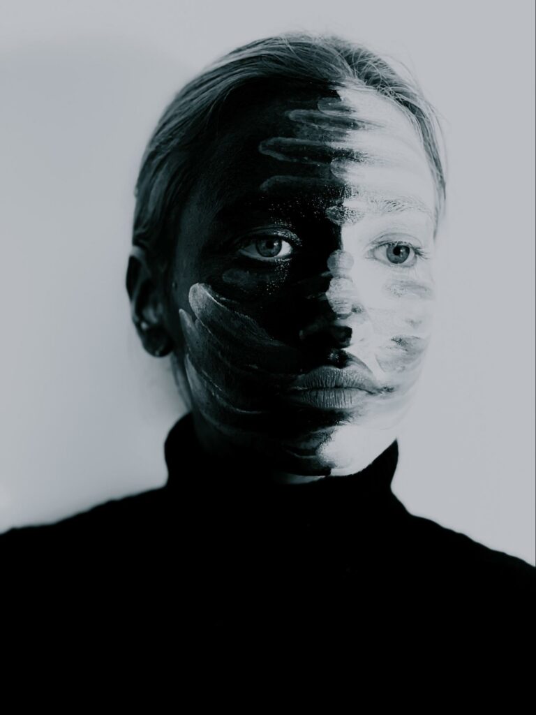 A girl with a painted face in contrast, black and white