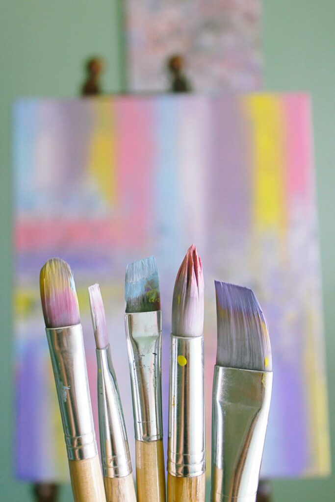  Five painting's brushes and canvas in pastel colors