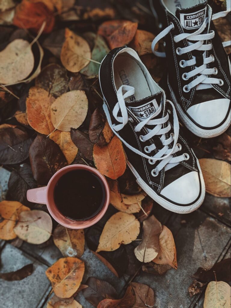 a pair of all star on autumn leaves