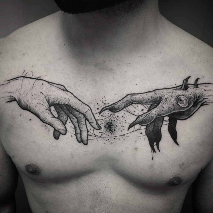 devil and human hands tattoo on the chest
