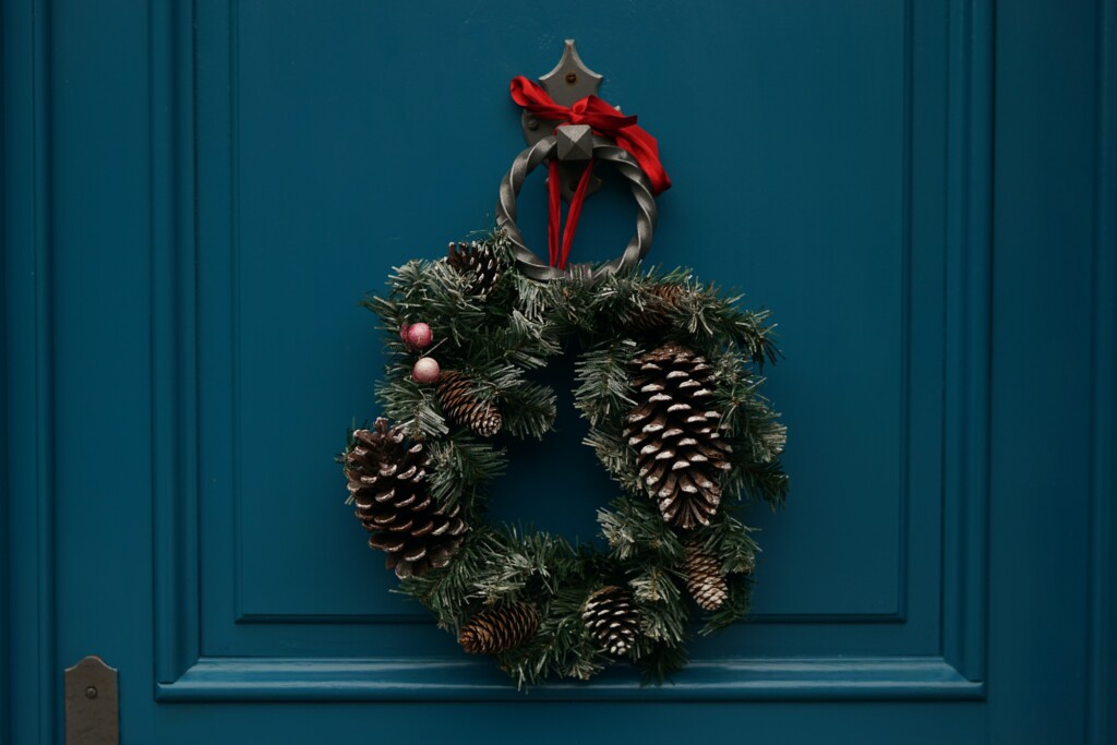 An image of a decorated wreath attached to a house.