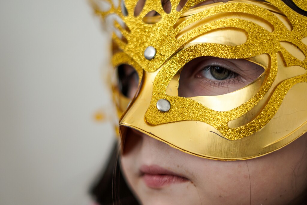  Picture of a child with a golden mask mask
