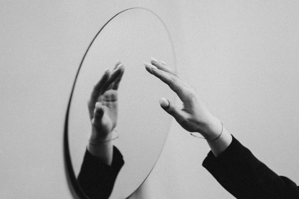 a picture of a mirror and a hand on it