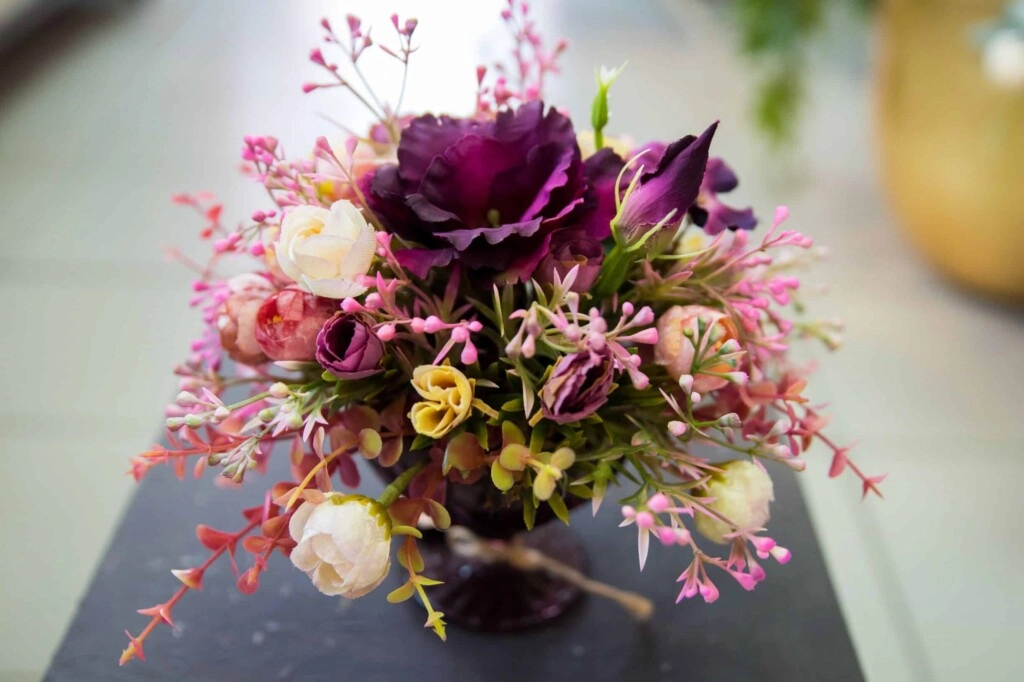 a bouquet with a purple flower in middle for emphasis