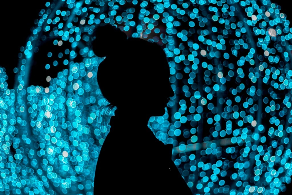 a girl with blue lights behind her