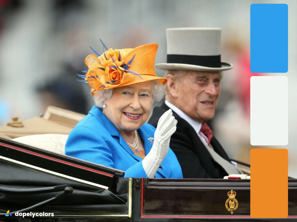 Queen wears a hat that has a complementary color with her dress
